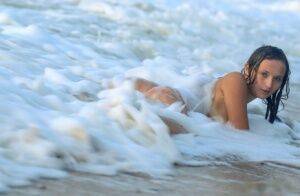 18-year-old beauty Tressa G strikes great nude poses in ocean surf on picsofsex.com