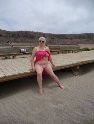 Older platinum blonde Barby exposes her plump body at the seaside on picsofsex.com