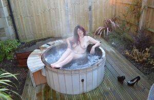 Amateur lady Barby Slut gets totally nude before getting in an outdoor hot tub on picsofsex.com