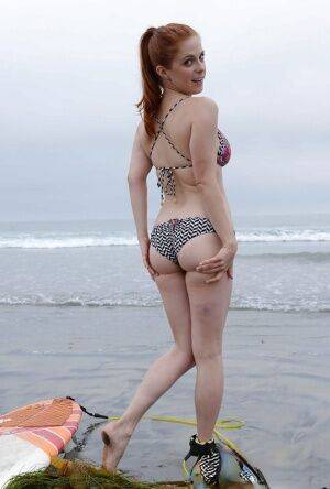 Ginger girl with large ass Penny is showing her skills on the beach on picsofsex.com