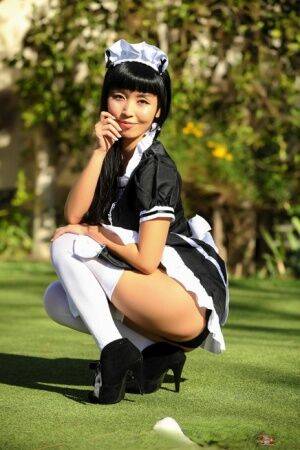 Japanese maid Marica Hase exposes her tits and twat on a putting green - Japan on picsofsex.com