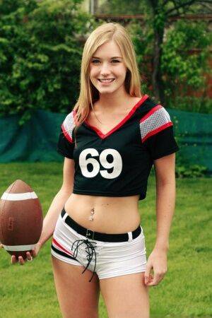 Beautiful blonde Jewel doffs sportswear to pose nude while holding a football on picsofsex.com