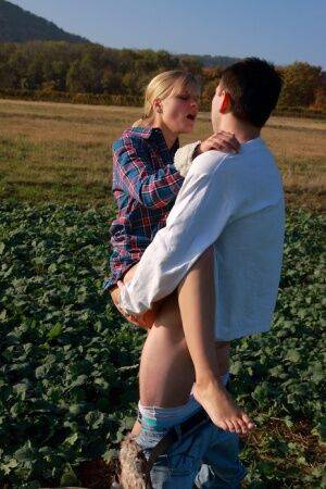 Blonde girl and her boyfriend have sex in a crop field away from prying eyes on picsofsex.com