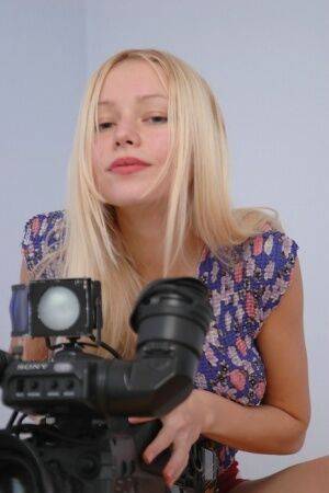 Anne stripping infront of a huge camera on picsofsex.com