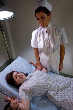 Restrained female is tortured and masturbated by a kinky woman on picsofsex.com