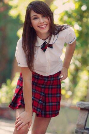 Charming student Marissa May gets naked in a garden while wearing white socks on picsofsex.com