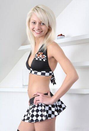 Young blonde Pinky June showcases her tight slit in long checker-board socks on picsofsex.com