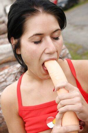 Filthy babe Nikki H masturbating her hairy muff with a toy outdoor on picsofsex.com