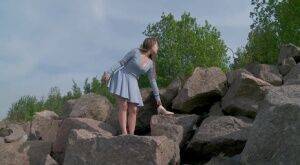 Barefoot girl Nastya squats for a piss on top of a bunch of boulders on picsofsex.com