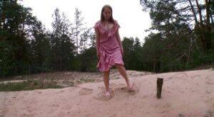 Distressed girl Nastya squats for an urgent piss on a sandbank on picsofsex.com