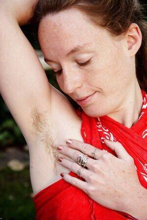 Barefoot redhead Ana Molly displaying hairy underarms and vagina outside on picsofsex.com