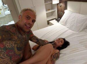 Tattooed couple engage in rough sex on top of their bed in self shot action on picsofsex.com