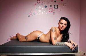 Tattooed female Christy Mack exposes her big tits and sexy as in heels on picsofsex.com