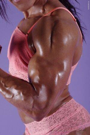 Female bodybuilder Karen Garrett flexes her muscles in lingerie on picsofsex.com