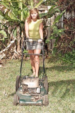Curvy May Malani gets horny mowing the lawn so she gets naked. on picsofsex.com