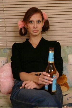 Young redhead chugs a beer before having sex with an older man on picsofsex.com