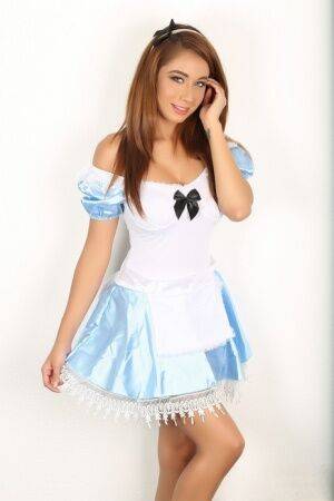 Naughty girl flashes no panty upskirt wearing Alice In Wonderland attire on picsofsex.com