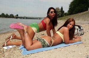 Lesbian babes Kyra Hot and Candy Coxx are having amazing time outdoor on picsofsex.com