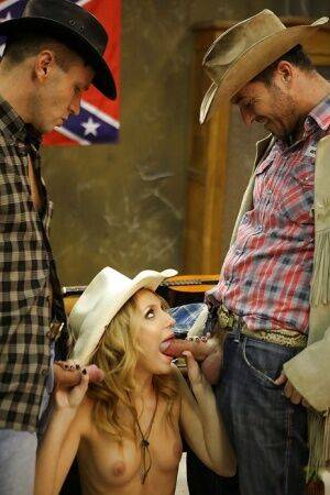 Slippy blonde cowgirl has some double penetration fun with two hung lads on picsofsex.com