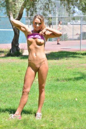 Fit blonde jogger in short shorts revealing wide open twat in public park on picsofsex.com