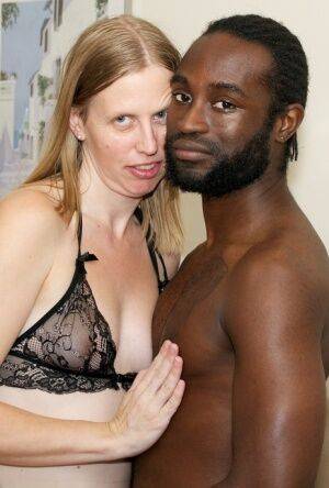 White amateur deepthroats her black lover's cock in lingerie ensemble on picsofsex.com