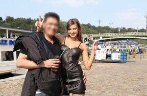 Skinny teen Maria in black leather dress strips naked at a public venue on picsofsex.com