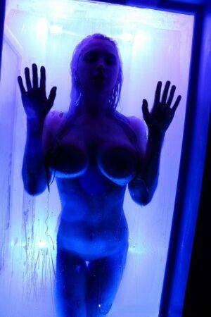 Alix Lynx presses her big tits against a shower stall while taking a shower on picsofsex.com