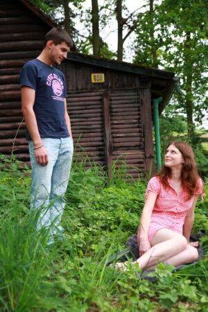 Young redhead and her boyfriend have sex outside a cabin in the woods on picsofsex.com