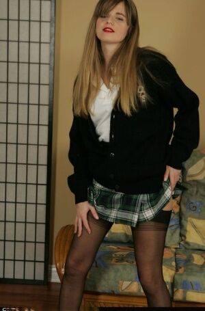 Naughty schoolgirl taking off her uniform and posing in lingerie on picsofsex.com