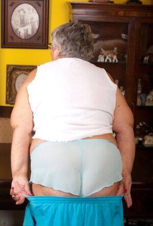 Obese UK lady Grandma Libby completely disrobes on a dining chair - Britain on picsofsex.com