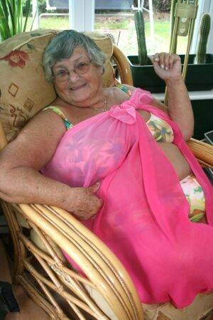 Horny old granny in glasses disrobes to reveal huge saggy tits & big BBW ass on picsofsex.com