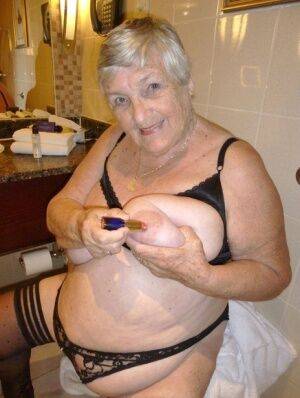 Fat nan Grandma Libby removes a bathrobe to pose nude in a cupless bra on picsofsex.com