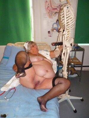 Fat old nurse Grandma Libby attaches a dildo to a skeleton for sexual relief on picsofsex.com