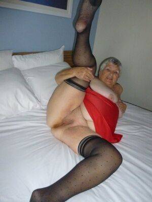 Fat man Grandma Libby doffs her lingerie before masturbating on her bed on picsofsex.com