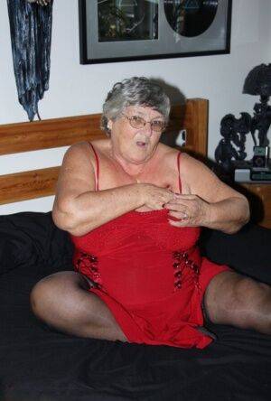 Overweight nan Grandma Libby finger fucks on a bed in lingerie and nylons on picsofsex.com