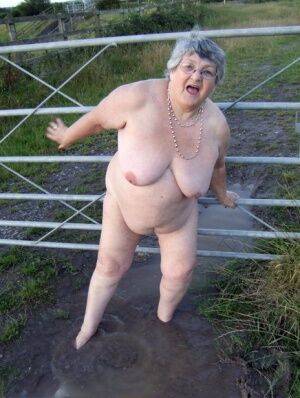 Fat nan Grandma Libby steps into a puddle before covering herself in mud on picsofsex.com