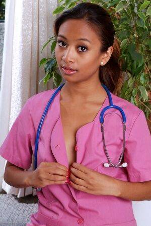 Amateur black babe bares shaved teen pussy after shedding nurse uniform on picsofsex.com