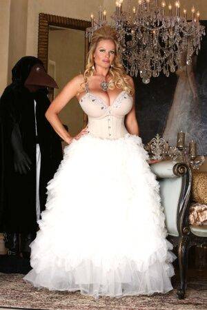 Blonde chick Kelly Madison releases her big tits from her white gown on picsofsex.com