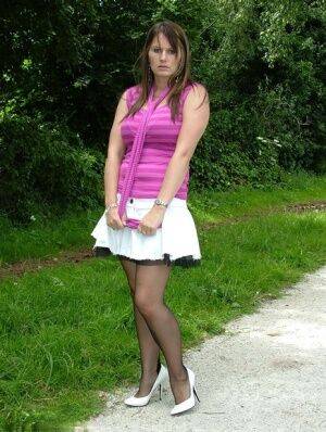 Outdoor posing from an non nude model Cathy in her white high heels on picsofsex.com