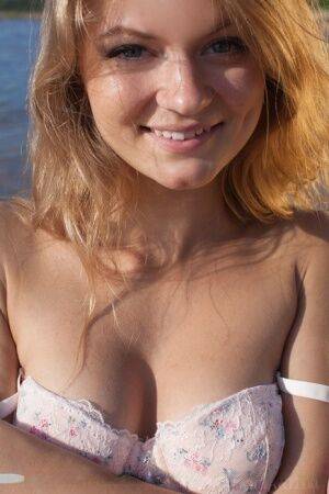 White teen Patritcy A slips off lace lingerie to pose naked at the beach on picsofsex.com