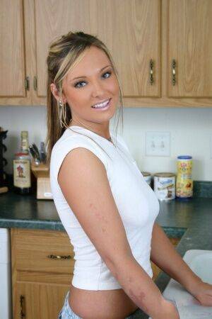 Horny girlfriend wets her white shirt in the kitchen showing her perky tits on picsofsex.com