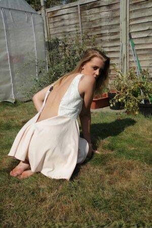 First timer Kaylee unzips a white dress to get naked in the backyard on picsofsex.com