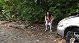 Dark haired girl Dee pulls down her white leggings for quick pee behind bushes on picsofsex.com