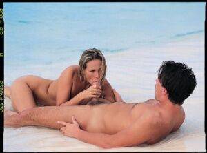 Hot blond chicks gets banged hard on the white sand of a tropical island beach on picsofsex.com