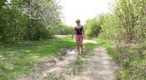 White girl Dafne pisses in a mud puddle while out for a walk in sunglasses on picsofsex.com