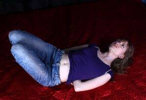 Barefoot white girl Agnes is hogtied in a shirt and blue jeans on picsofsex.com