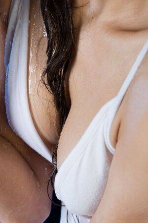 Gorgeous teen Sandra Lauver removes a white dress while getting wet on picsofsex.com