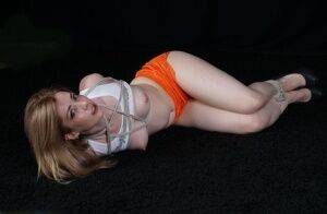 White girl with perky tits is blindfolded after being hogtied in shorts on picsofsex.com