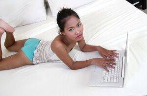 Petite Asian girl launches her nude modeling career atop white bed sheets on picsofsex.com