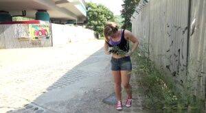 White girl pulls down her panties before squatting for a piss on country road on picsofsex.com